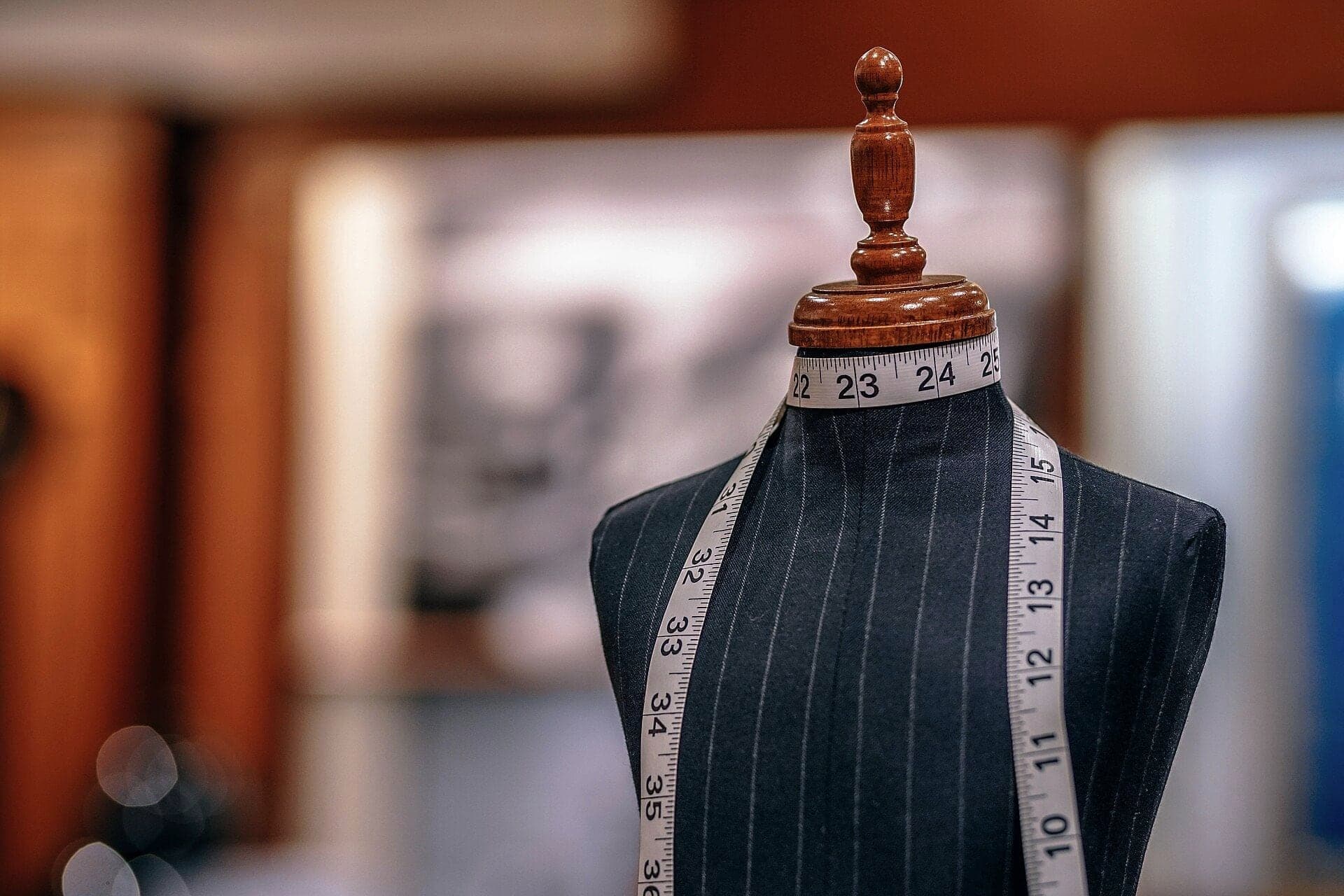 A tailor's dress form with a measuring tape in the atelier
